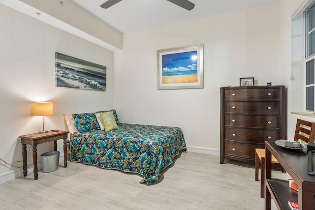 bedroom featuring a ceiling fan, baseboards, and wood finished floors