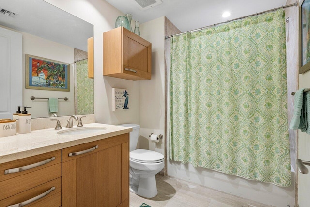 full bathroom with visible vents, shower / tub combo with curtain, vanity, and toilet