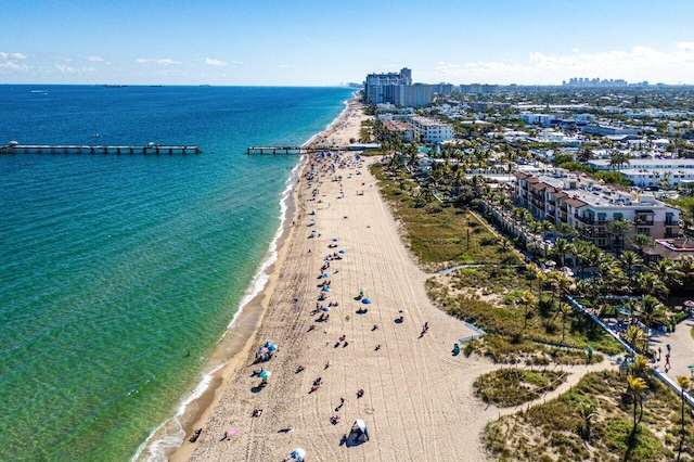 aerial view with a water view and a beach view