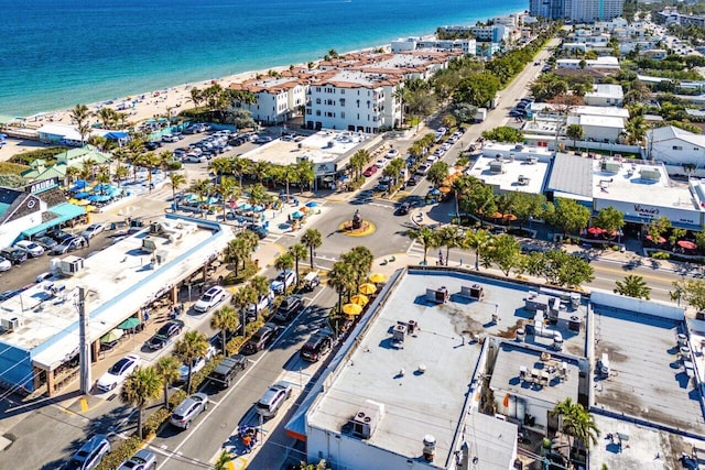 birds eye view of property with a water view and a view of the beach