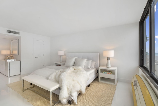 bedroom featuring washer / clothes dryer, visible vents, and baseboards