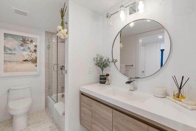 bathroom with toilet, shower / bath combination with glass door, vanity, and visible vents