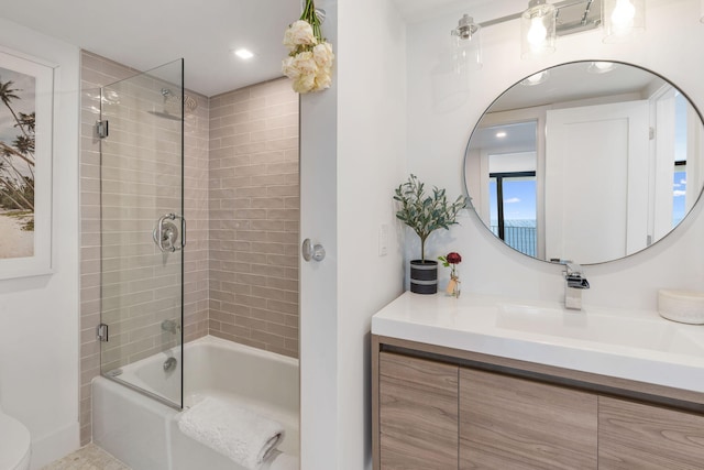 full bathroom featuring shower / bath combination with glass door, vanity, and toilet