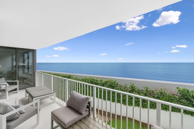 balcony featuring a water view and a view of the beach