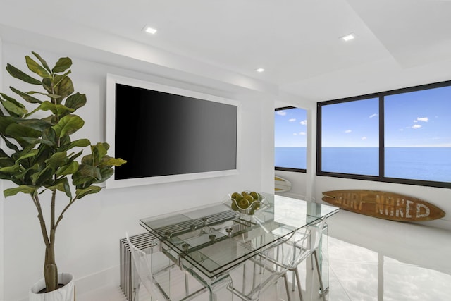 unfurnished dining area with recessed lighting, radiator, and a water view