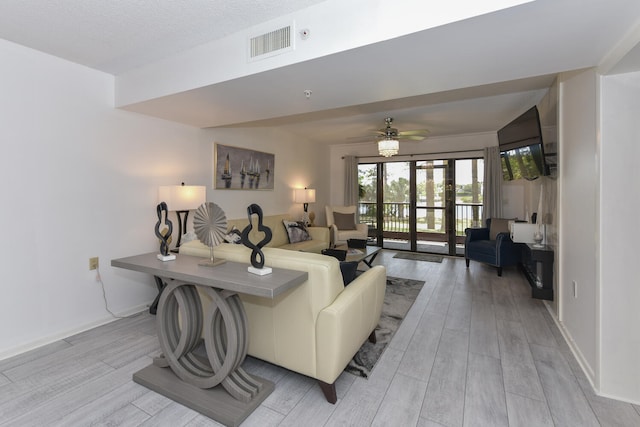 1001 Seafarer Cir Unit 102, Jupiter, FL 33477 - living room featuring light wood-style flooring, a ceiling fan, and baseboards
