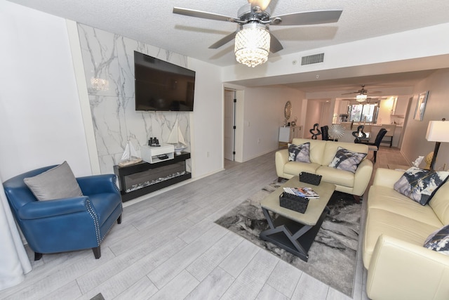 1001 Seafarer Cir Unit 102, Jupiter, FL 33477 - living area with a ceiling fan, wood finished floors, and a textured ceiling