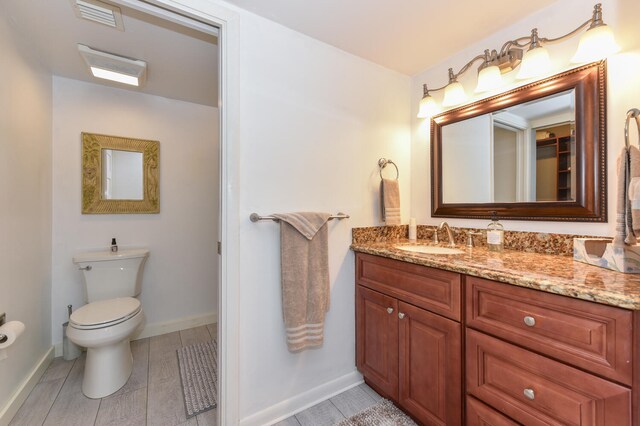1001 Seafarer Cir Unit 102, Jupiter, FL 33477 - bathroom with vanity, toilet, and baseboards