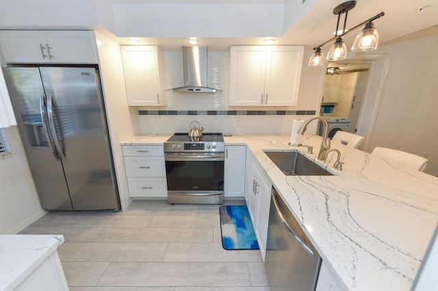 1001 Seafarer Cir Unit 102, Jupiter, FL 33477 - kitchen with wall chimney range hood, stainless steel appliances, a sink, and light stone countertops