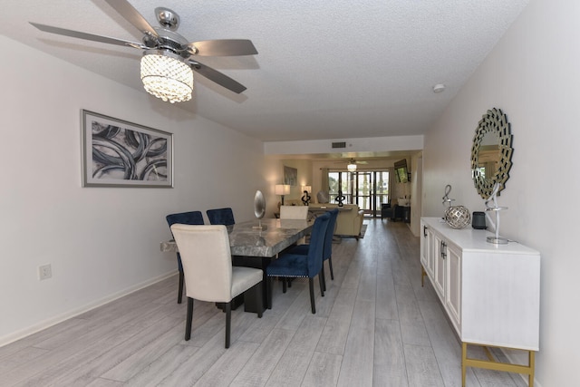 1001 Seafarer Cir Unit 102, Jupiter, FL 33477 - dining space with a ceiling fan, light wood-type flooring, and a textured ceiling