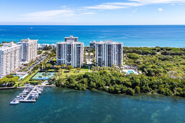 birds eye view of property with a view of city and a water view