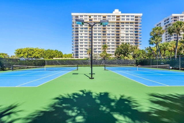 view of sport court featuring fence