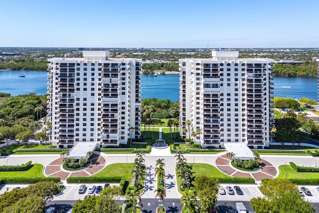 drone / aerial view featuring a view of city and a water view