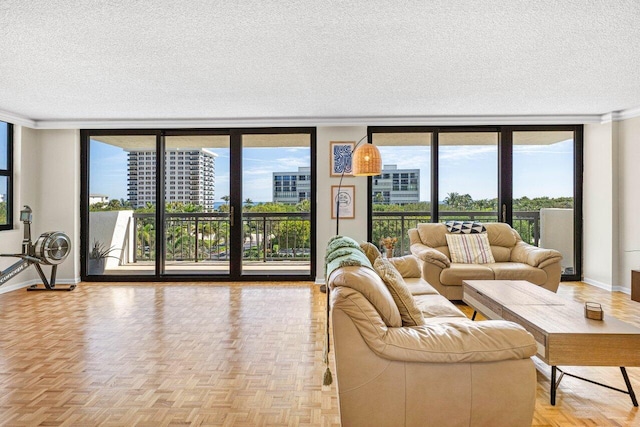 living room with baseboards, floor to ceiling windows, a textured ceiling, and ornamental molding