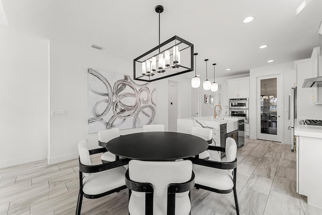 dining space featuring baseboards, visible vents, and recessed lighting