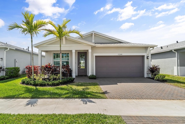 ranch-style house with a garage and decorative driveway