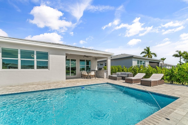 outdoor pool featuring a patio area, ceiling fan, and an outdoor living space