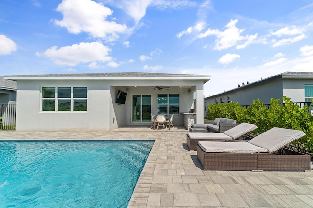 rear view of house featuring ceiling fan, an outdoor hangout area, stucco siding, an outdoor pool, and a patio area