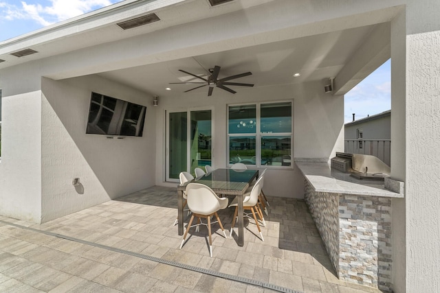 view of patio / terrace with a ceiling fan, outdoor dining area, and area for grilling