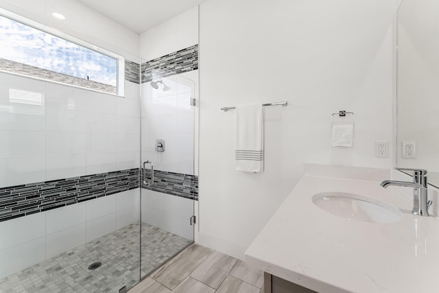 full bathroom featuring a stall shower and vanity