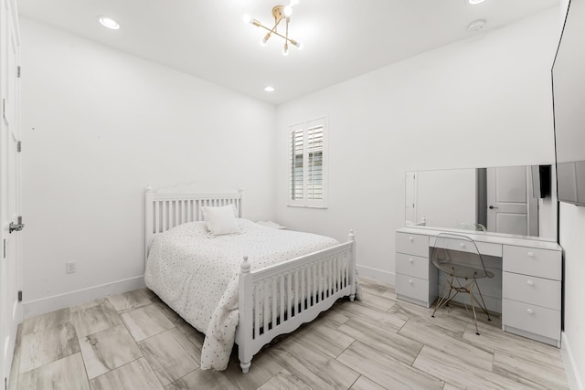 bedroom with recessed lighting, a notable chandelier, and baseboards