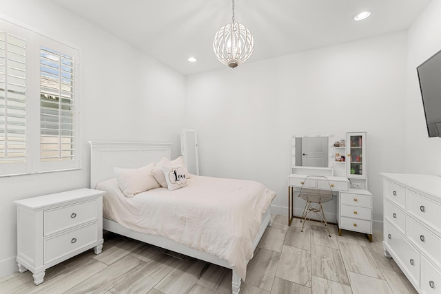 bedroom featuring a chandelier, wood tiled floor, baseboards, and recessed lighting