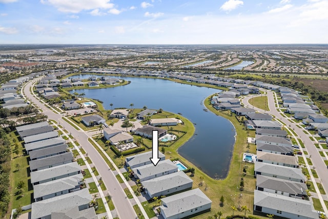 drone / aerial view featuring a water view and a residential view