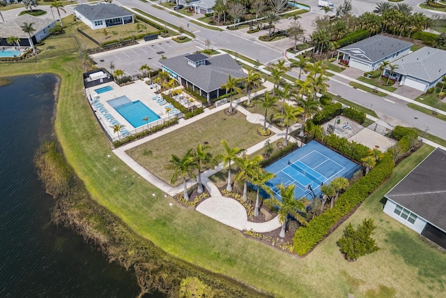 birds eye view of property with a water view and a residential view