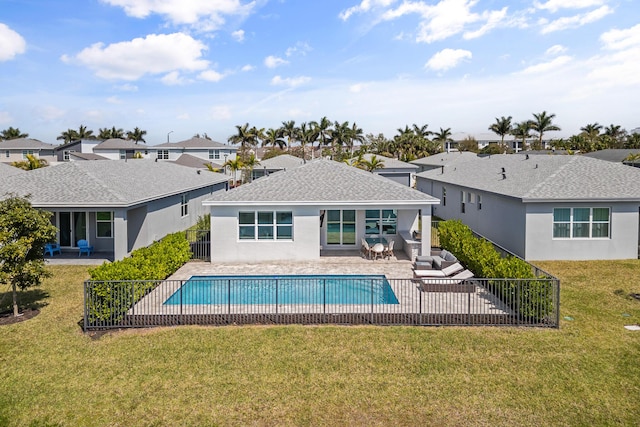 view of pool with a fenced in pool, a patio area, a residential view, and a lawn