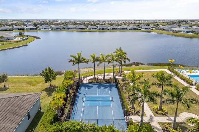 drone / aerial view featuring a water view and a residential view