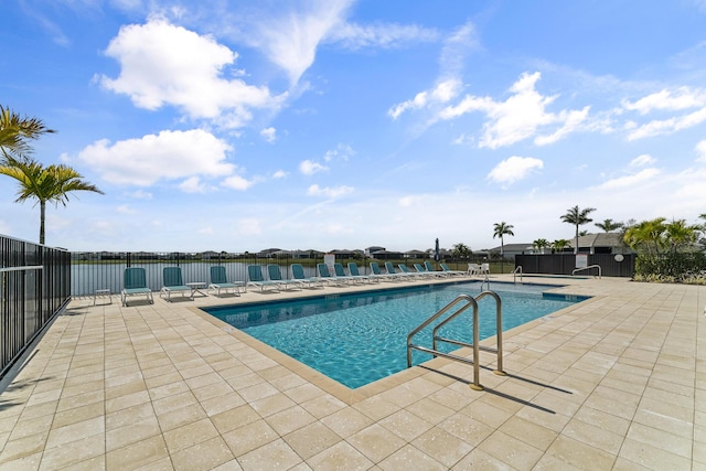 pool with a patio and fence