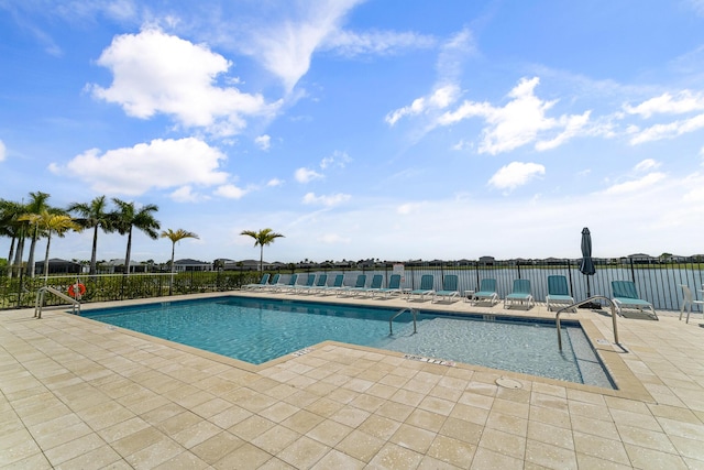 community pool featuring a patio area and fence