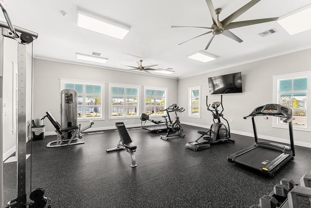 workout area featuring baseboards, ornamental molding, visible vents, and a healthy amount of sunlight