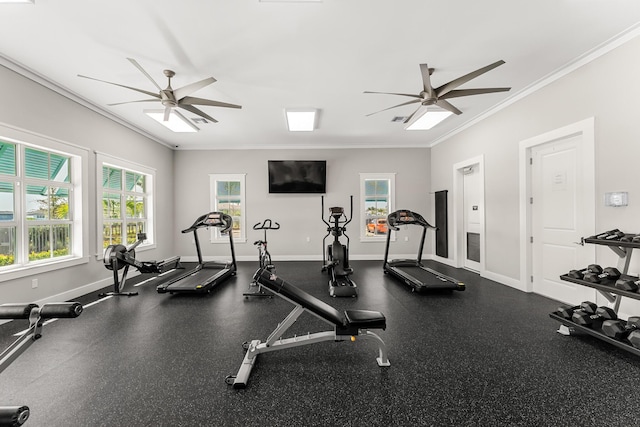 workout area featuring baseboards, ceiling fan, and crown molding