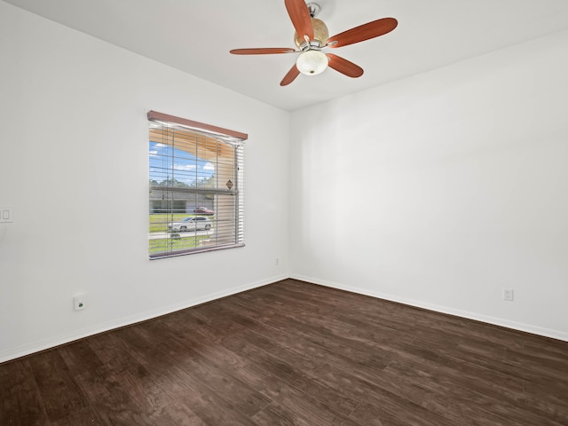 unfurnished room with ceiling fan, wood finished floors, and baseboards