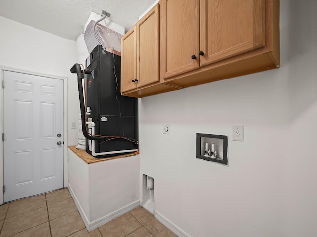 laundry room with light tile patterned floors, hookup for a washing machine, hookup for an electric dryer, baseboards, and cabinet space