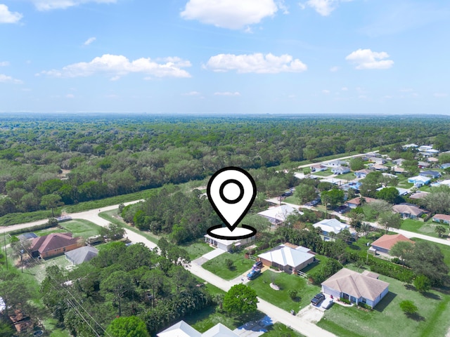 bird's eye view with a wooded view