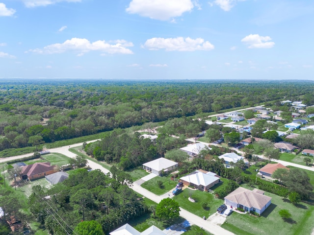 birds eye view of property featuring a view of trees