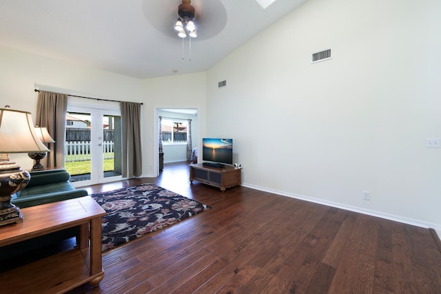 living area with ceiling fan, wood finished floors, visible vents, and baseboards