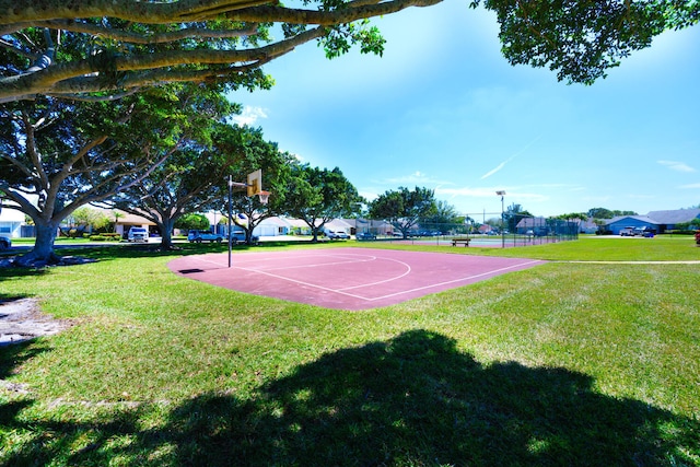 view of sport court with community basketball court, a yard, and fence