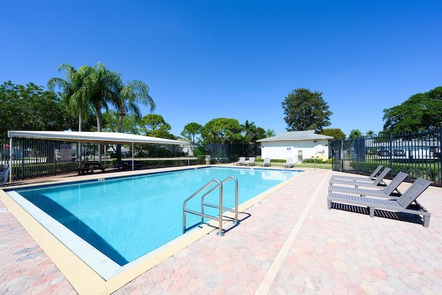 community pool featuring a patio and fence