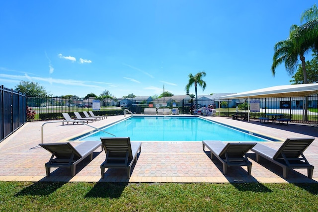 pool with fence and a patio