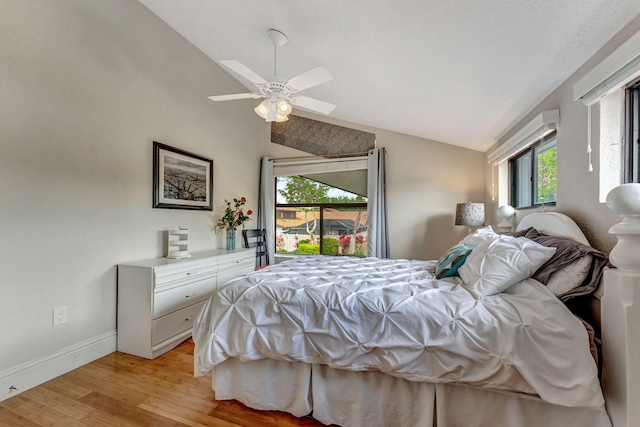 bedroom with light wood-style floors, ceiling fan, baseboards, and vaulted ceiling