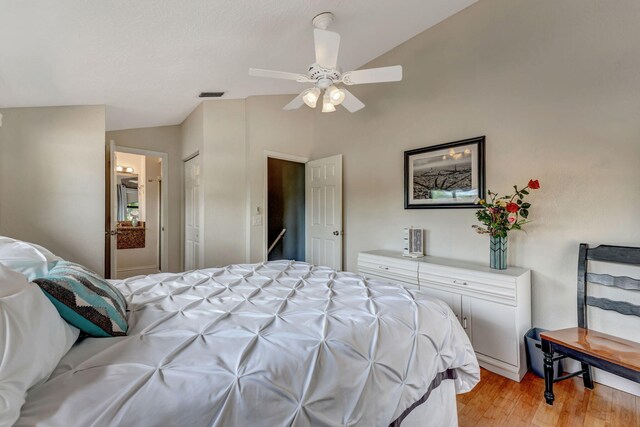 bedroom featuring vaulted ceiling, ceiling fan, light wood-style flooring, and visible vents