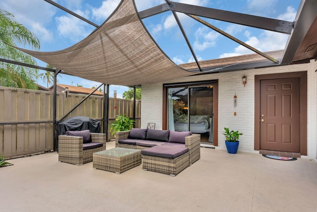 view of patio / terrace featuring glass enclosure, fence, and an outdoor living space