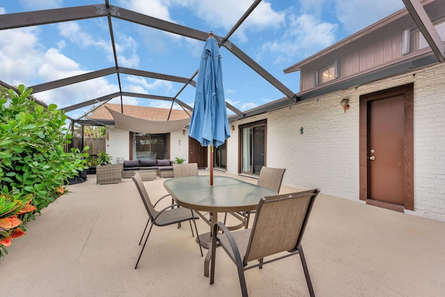view of patio featuring outdoor lounge area and glass enclosure
