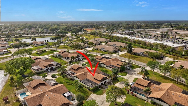 bird's eye view with a water view and a residential view