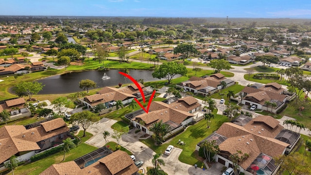 drone / aerial view featuring a residential view and a water view