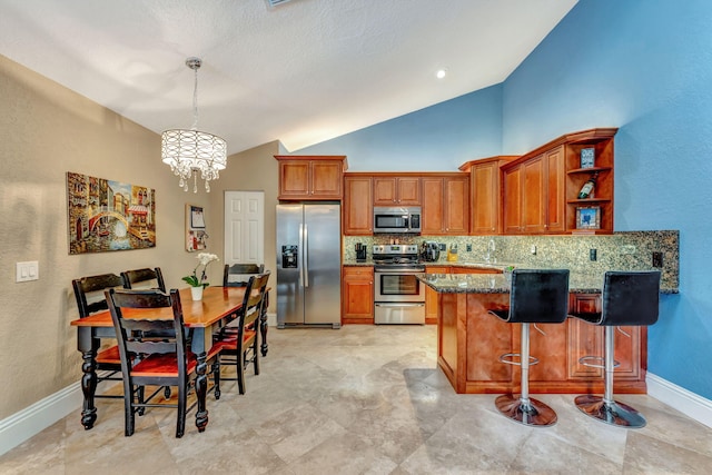 kitchen with brown cabinetry, a notable chandelier, stainless steel appliances, and tasteful backsplash