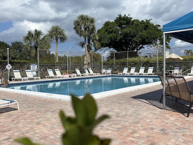 pool featuring a patio area and fence